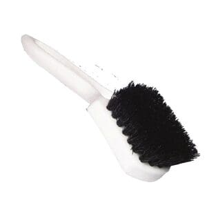 A black and white brush is on the handle.