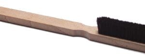 A wooden handle with a black brush on top of it.
