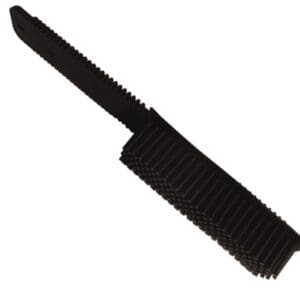 A black brush is laying on the ground