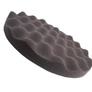 A black foam pad is sitting on top of the floor.