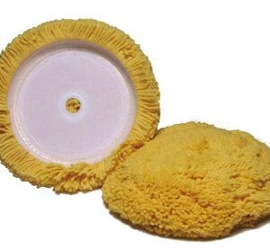 Thick yellow polishing pad beside white backing disc