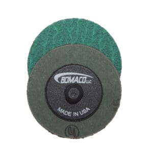 A pair of green and black discs are next to each other.