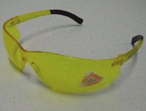 A pair of yellow safety glasses on top of a table.