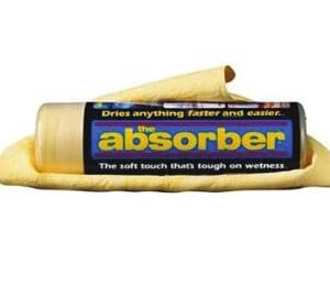 A tube of wax is sitting on top of a yellow cloth.