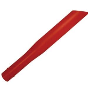 A red plastic stick is laying on the ground.